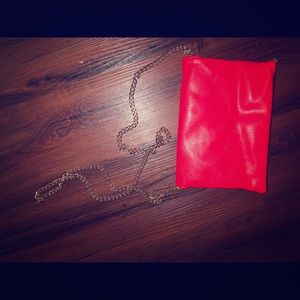 Red shoulder bag that could be worn as a clutch